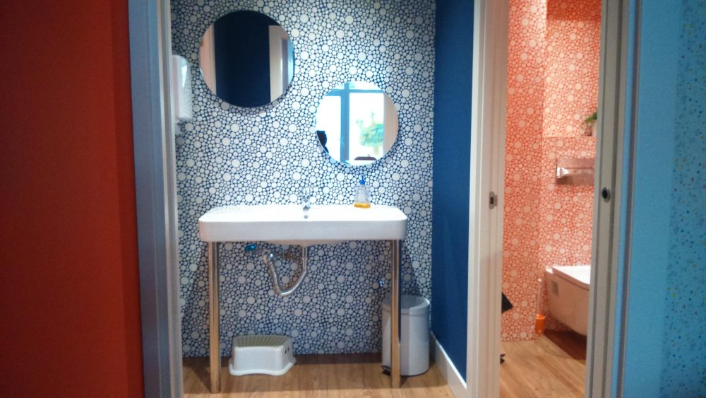 Uno de los baños, con lavabo y azulejos de colores